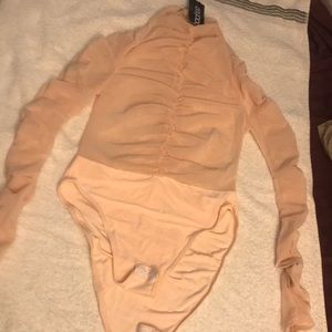 Mesh material for upper half. Mock neck.